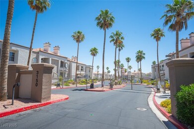 View of asphalt road with a gated entry, a residential view, curbs, and a gate