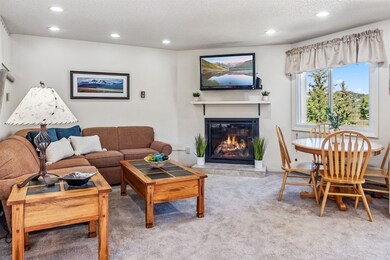 The spacious living room features a modern firepla