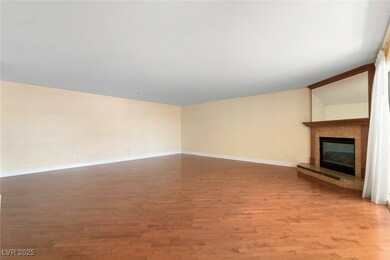 Unfurnished living room featuring a tiled fireplac