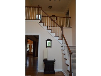 Beautiful hardwood floors and an open staircase le