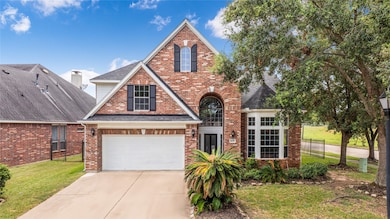 This is a two-story brick home  featuring a pitche