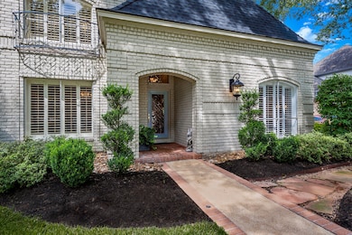 The covered brick porch is anchored on either side by flowerbeds waiting on their seasonal change of color. A full sprinkler system and bullrock at the foundation not only keep the yard beautiful, but also help ease the burden of homeowner maintenance. Lovely coach lighting adds not only curb appeal but illumination to the front of the house.