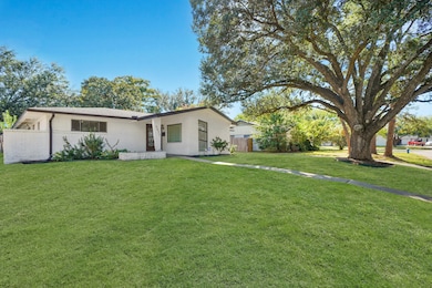 View of the Landscaped Front Yard Showcasing the Majestic Oak Tree - Such a Beautiful Shade Tree!