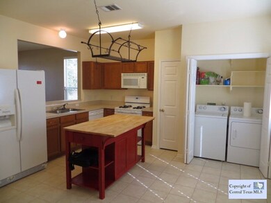 Kitchen: Wide open kitchen with laundry facilities