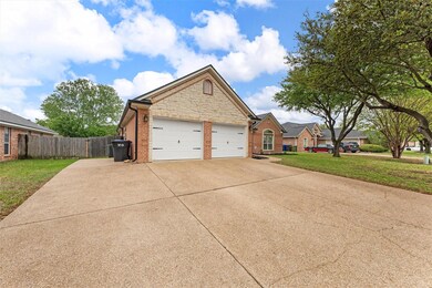 View of front of home with a front yard, an attach