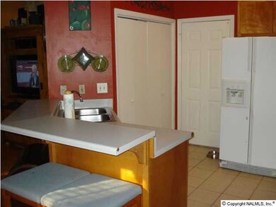 Another view of the kitchen which also features a large Pantry.