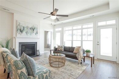 Living room with ceiling fan, a wealth of natural
