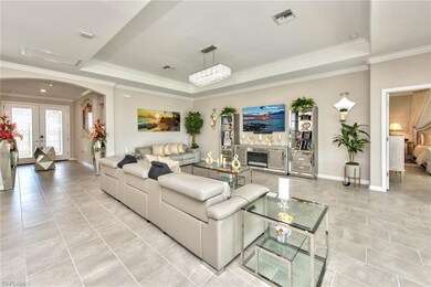 Great room with tray ceiling and hallway leading t