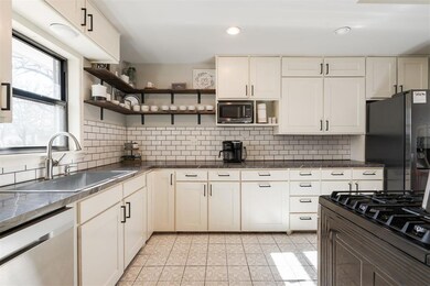 Kitchen featuring tasteful backsplash, light tile 