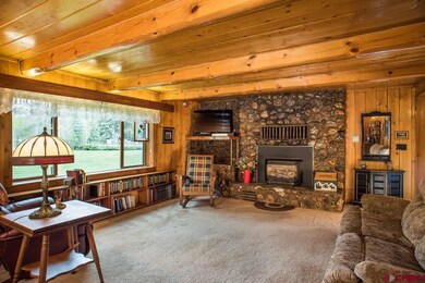 Spacious Living Area with Native Stone Fireplace