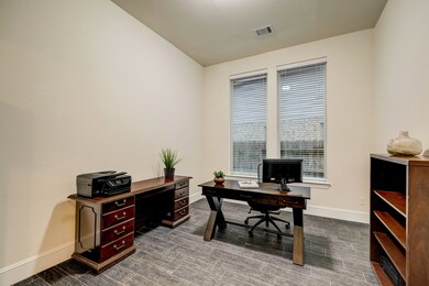 Double French doors grace the entry to a perfect sized study. Could also be a playroom!