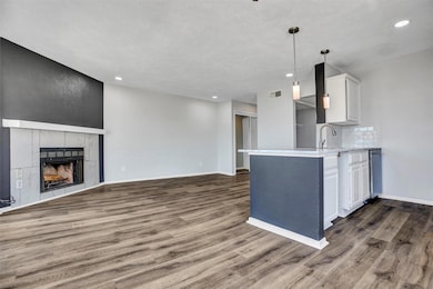 Kitchen featuring white cabinets, hanging light fi