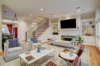 To the right of the Entry is the Living Room featuring a wood burning fireplace with gas logs, built-ins, hardwood floors and double crown moulding. Can you hear the music play?  With the built-in speakers you bet you can!