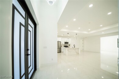 Entryway featuring a tray ceiling, recessed lighti