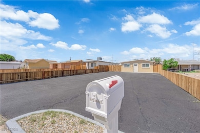 View of asphalt driveway featuring a residential v