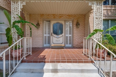 View of exterior entry with brick siding