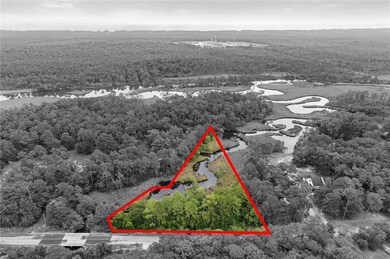 View of property location with a nearby body of water and property parcel outlined