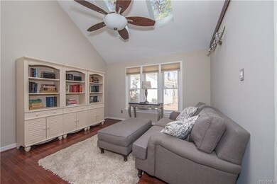 Family room with vaulted ceiling and hardwood floo