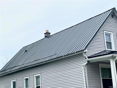 Vinyl siding and metal roof. All windows are wrapp