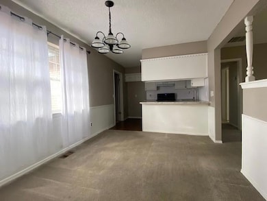 Kitchen with visible vents, dark carpet, stove, a 