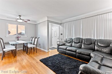 Living area featuring light wood-type flooring and a ceiling fan