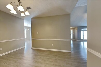 Unfurnished room featuring a chandelier, hardwood 