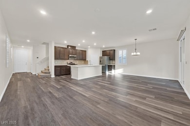 Unfurnished living room featuring dark wood-type f
