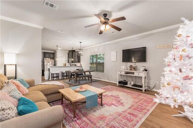 Living room with wood-type flooring, ceiling fan w
