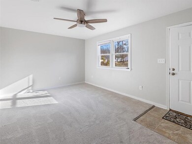 Living Room w/ updated Light/Fan Fixture, NEW Carpet, Double Windows, Front Entry