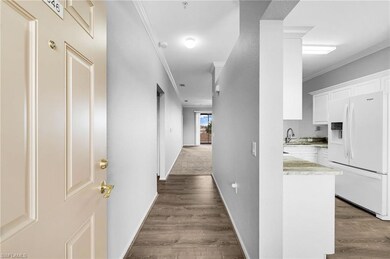 Hallway with ornamental molding, baseboards, dark 