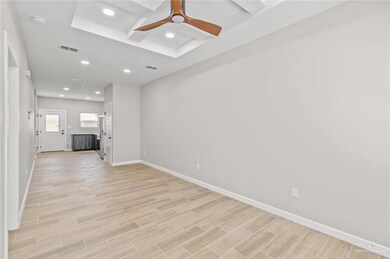 Unfurnished living room with baseboards, recessed lighting, light wood finished floors, coffered ceiling, and beamed ceiling