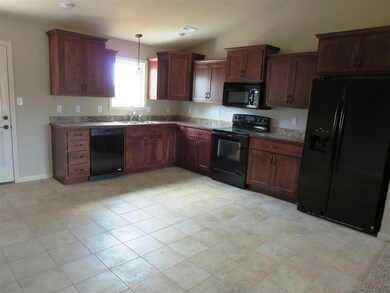 Kitchen with staggered cabinetry. All appliances included.
