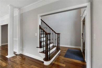 Stairway with visible vents, baseboards, crown mol