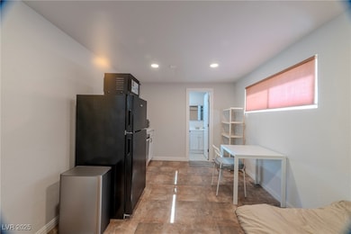 Kitchen with freestanding refrigerator and recessed lighting