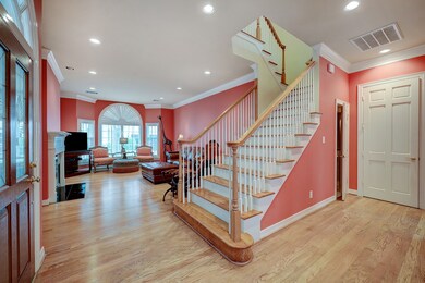 LIVING ROOM: 22 X 16. Recently refinished hardwoods, light filled room with fireplace.