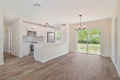 Kitchen featuring stainless steel appliances, a ch