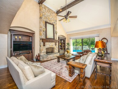 Handsome hardwoods and soaring beamed ceilings grace this stunning Living Room.