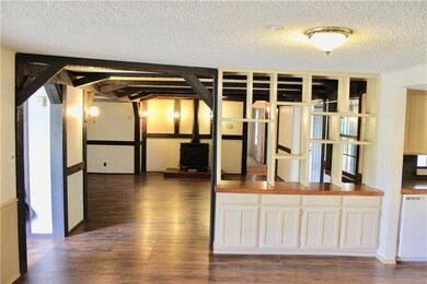 View of living room from kitchen and dining area