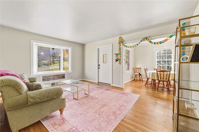 Living area featuring light wood-style flooring and baseboards