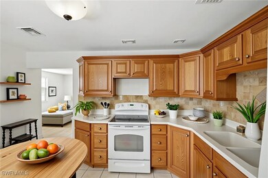 Kitchen featuring white range with electric cookto