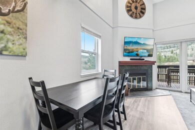 Dining area with wood finished floors, a fireplace