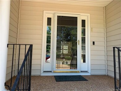 Nice covered front porch with aggregate and storm 