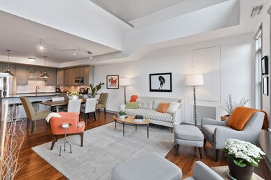 Spacious living room open to dining area and kitchen.  Wonderful light throughout unit.  Plenty of wall space for art displays.