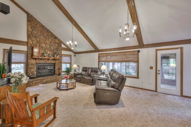 Living room with a fireplace, beamed ceiling, a no