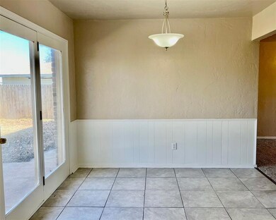 Tiled spare room featuring a wealth of natural lig