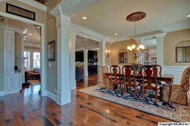 IMPRESSIVE ENTERTAINING WILL BE YOURS IN THIS FORMAL DINING ROOM WITH HEAVY WOOD MOLDINGS AND AMAZING HARDWOOD FLOORS. THIS BANQUET STYLE DINING ROOM EASILY SEATS 12!