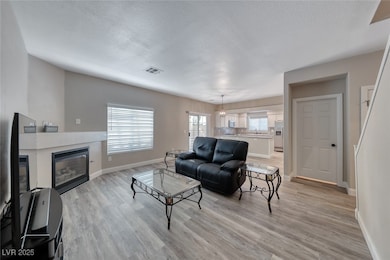 Living room featuring a textured ceiling, light wo