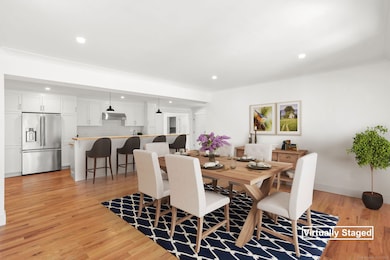 Option 1:Virtually staged, kitchen flowing into spacious dining room.