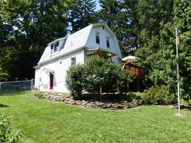 Exterior Back. The back of the home is as cute as the front.  The convenient side door opens into the fenced yard, and the deck has stairs to the yard.