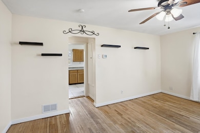 Unfurnished room featuring light wood-style flooring and ceiling fan